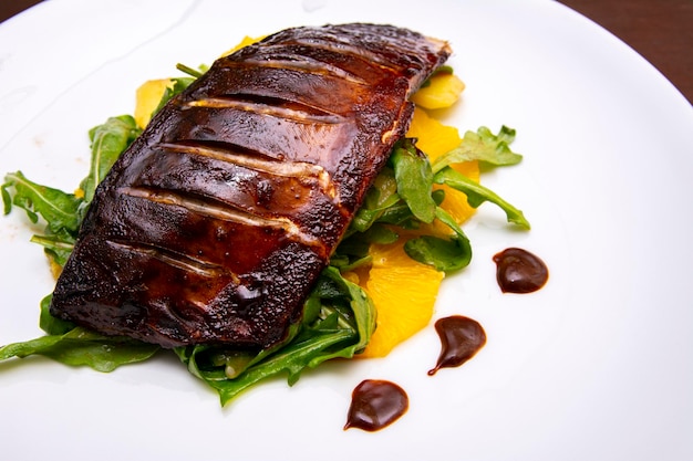 Baked mackerel on a pillow of pineapple and arugula Beautiful author's seafood dish