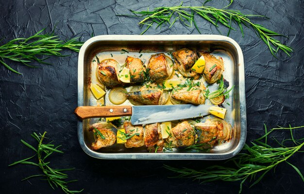 Baked mackerel with onions and herbs.Roasted fish in a baking dish.Seafood