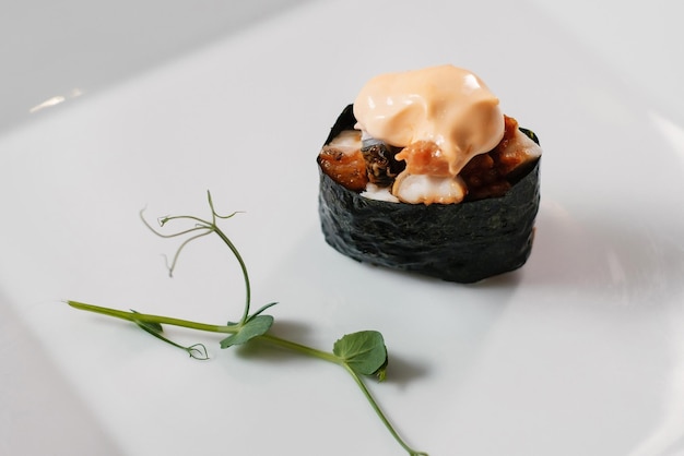 Baked maki sushi rolls with salmon and greeneryxA