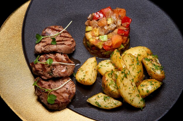 Baked meat and vegetables on the dish.