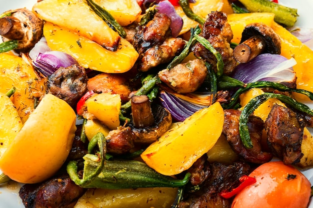 Baked meat with potatoes,apples,mushrooms and okra.Roasted meat with vegetables.