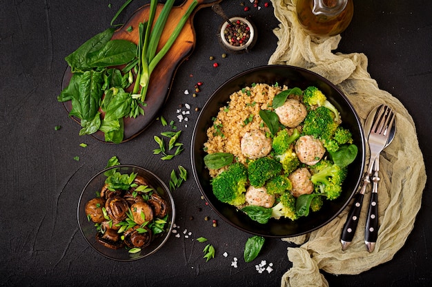 Baked meatballs of chicken fillet with garnish with quinoa and boiled broccoli. 