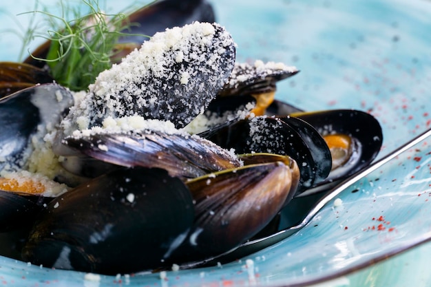 Baked mussels sprinkled with parmesan