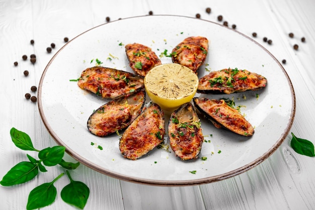 Baked mussels with cheese on plate