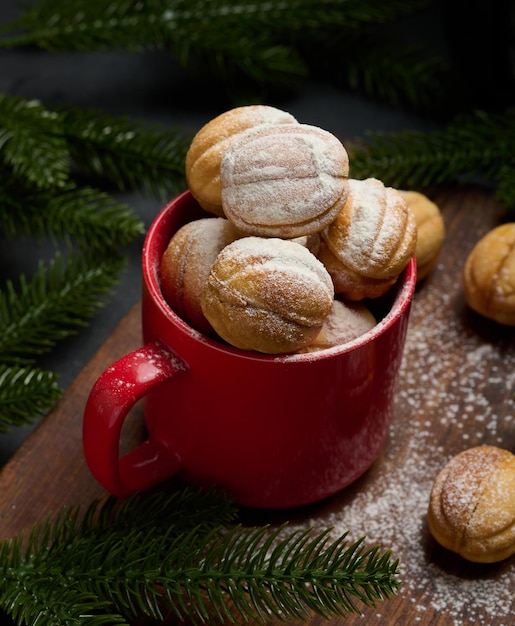 Baked nutshaped dessert in a red ceramic mug