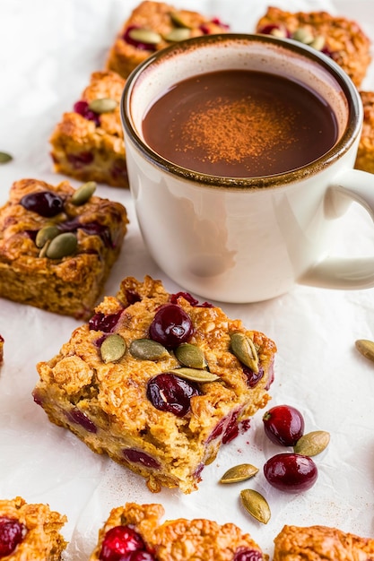 Baked oatmeal squares with cranberry and pumpkin seeds with spicy hot cocoa