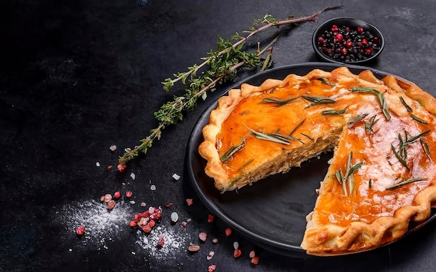 Baked Ossetian pie with beef meat and herbs Black background