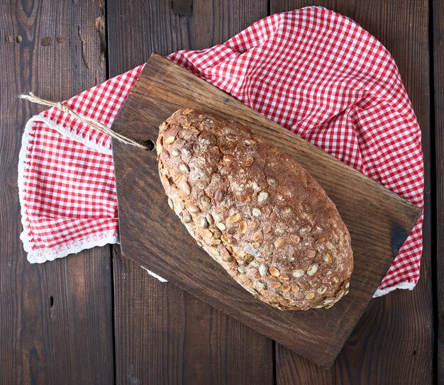 Baked oval bread made from rye flour with pumpkin seeds 