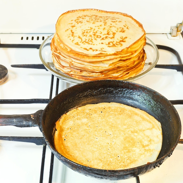 Baked pancake and stack of prepared pancakes