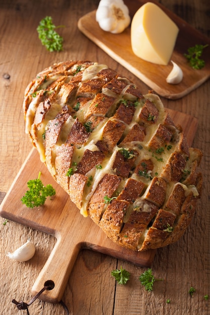 Baked party bread with melted cheese butter herbs