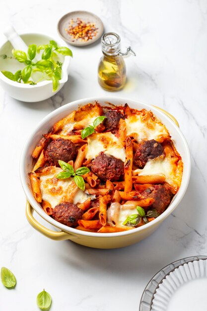 Baked penne pasta with meatballs and mozzarella