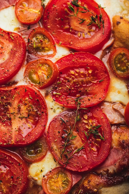 Photo baked pizza with whole grain dough, tomato, ham, mozzarella, tomato sauce, thyme.close up.