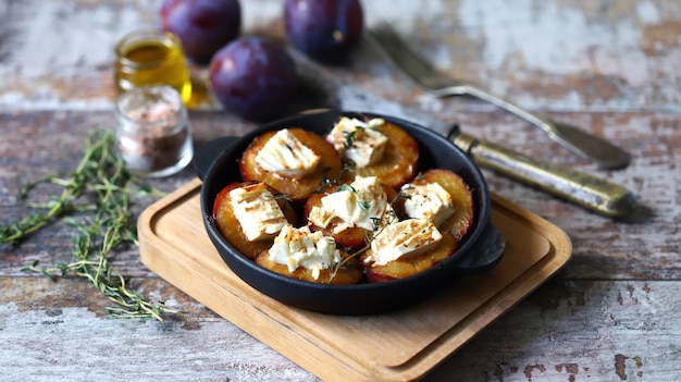 Baked plums with white cheese and herbs