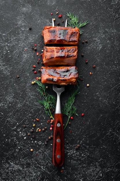 Baked pork ribs on a fork Barbecue menu Top view