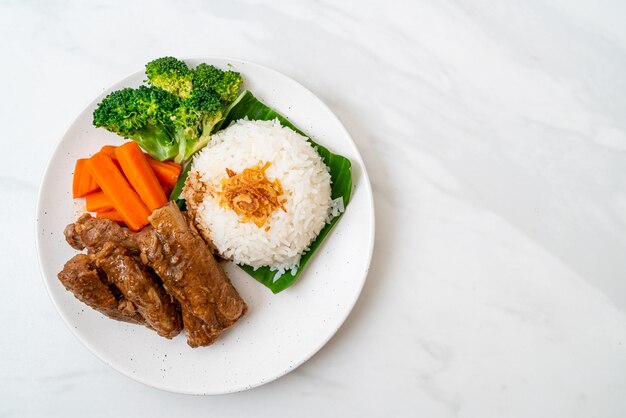 Baked pork ribs with sauce and rice