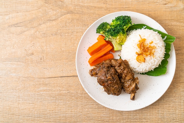 Baked pork ribs with sauce and rice