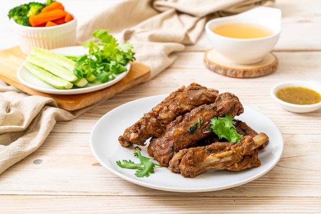 Baked pork ribs with sauce and vegetable