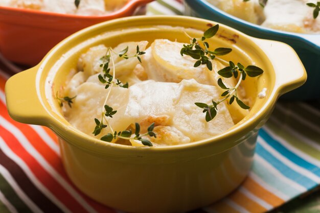 Baked potato casserole with cream sauce with thyme, gratin Dauphinois