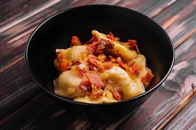 Baked potato dumplings with fried bacon and onions