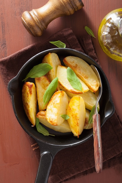 Baked potato wedges in black frying pan