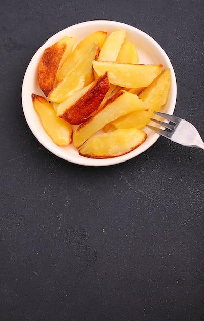 Baked potatoes on a black background