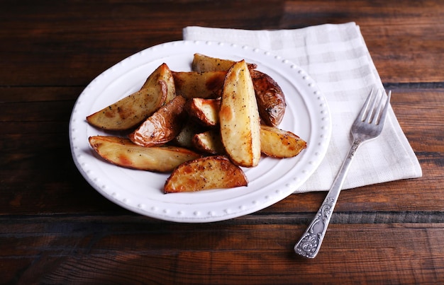 Baked potatoes on pate on wooden table