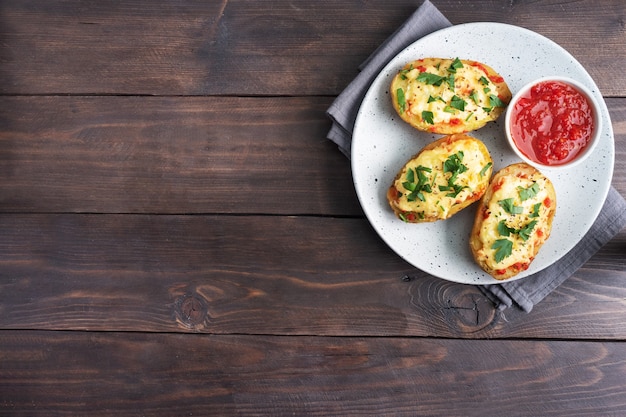 Baked potatoes in the peel stuffed with cheese and herbs