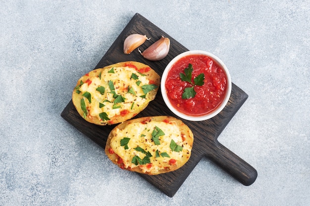 Baked potatoes stuffed with cheese and herbs