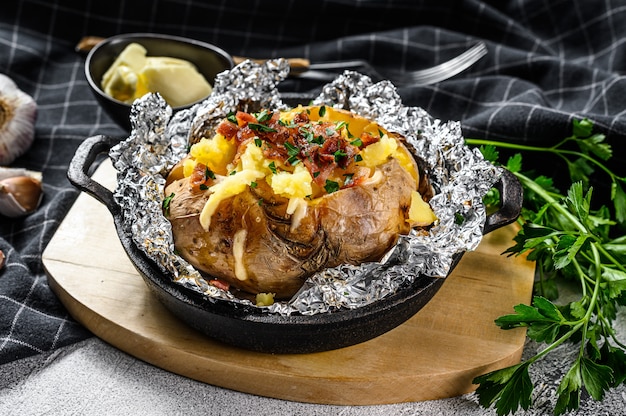 Baked potatoes with bacon, green onion and cheese.