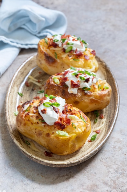 Premium Photo | Baked potatoes with cheese and bacon