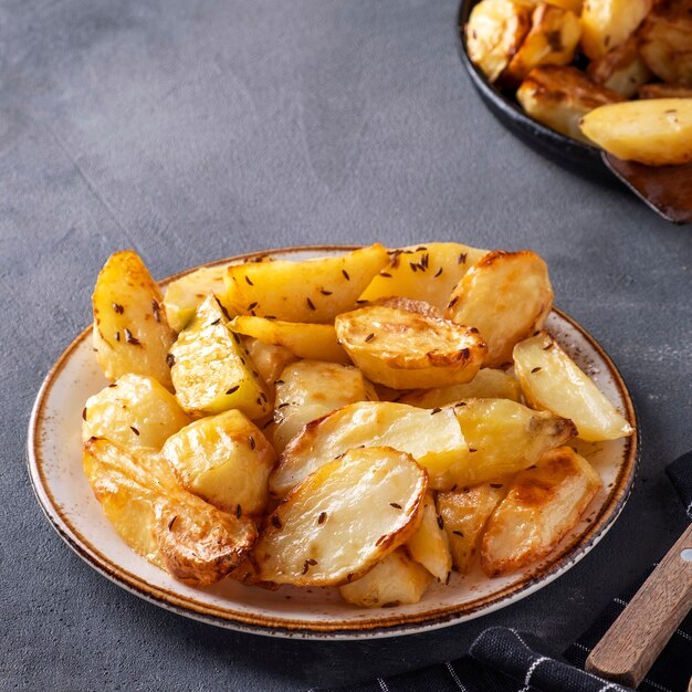 Baked potatoes with cumin on a plate