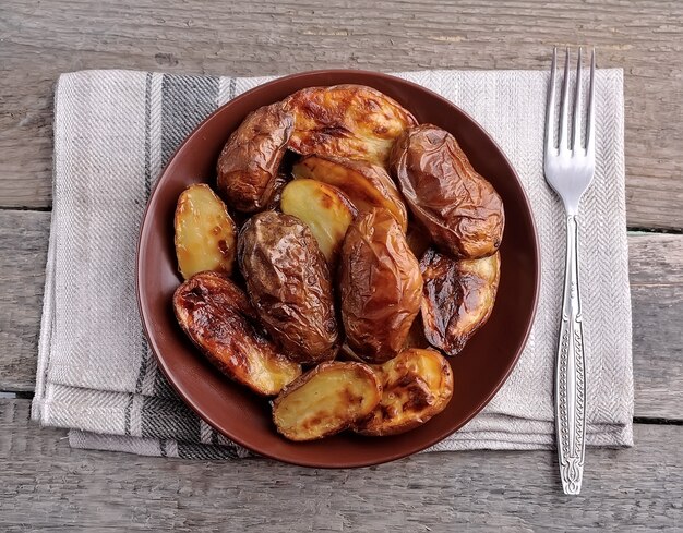 Baked potatoes on wooden tables