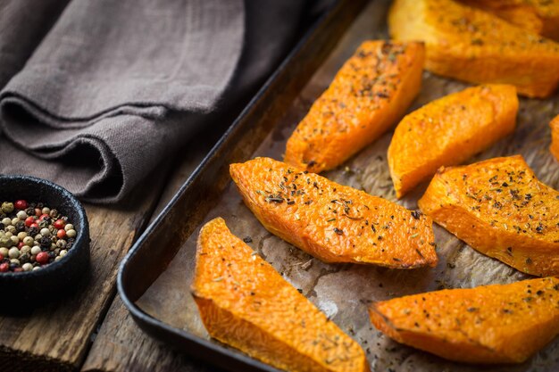 Baked pumpkin slices with honey, oil and herbs