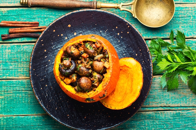 Baked pumpkin stuffed with mushrooms and rice.Traditional autumn food