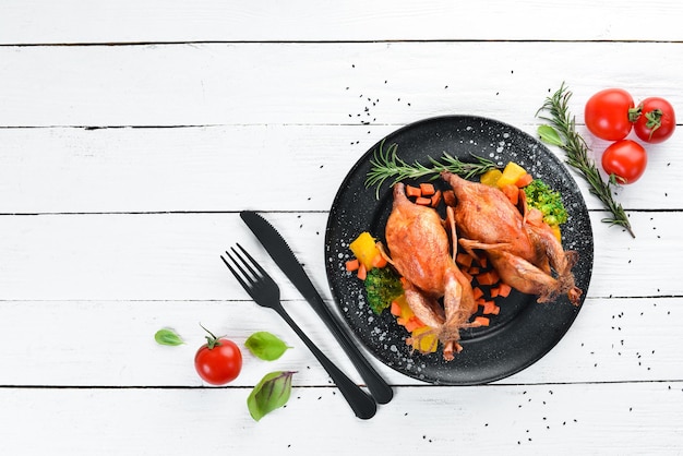 Baked quail On a white wooden background Top view Free space for your text