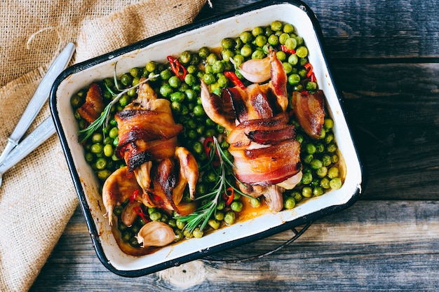 Baked quail with bacon and peas