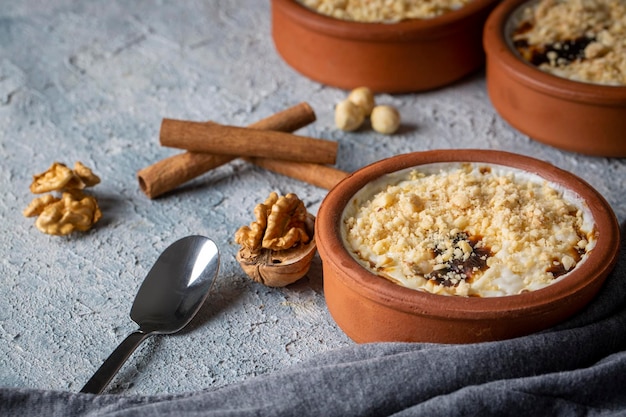 Baked rice pudding turkish milky dessert sutlac in earthenware casserole with hazelnuts