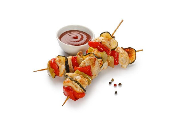 Baked roasted Chicken meat with sweet pepper zucchini on skewers isolated on a white background