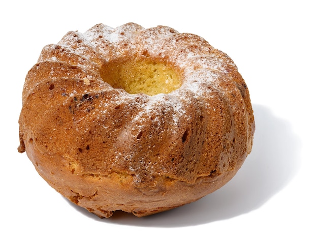 Baked round cupcake sprinkled with sugar on a white isolated background