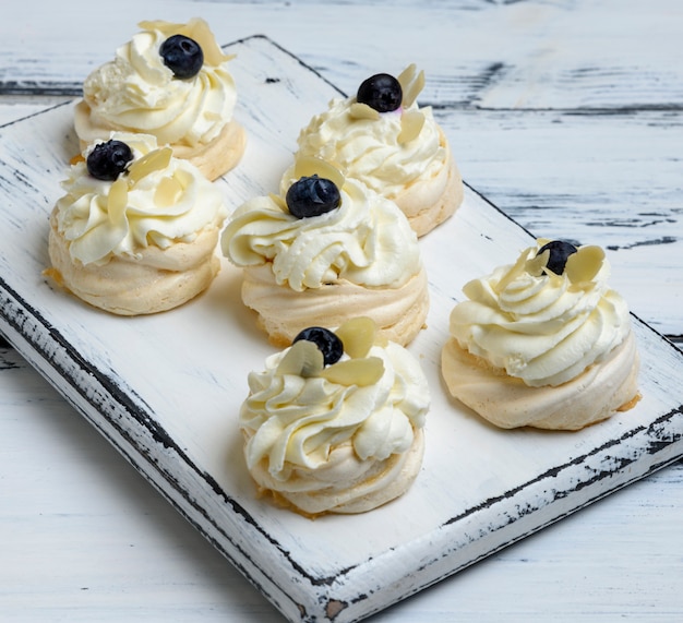 Baked round meringues with whipped cream 