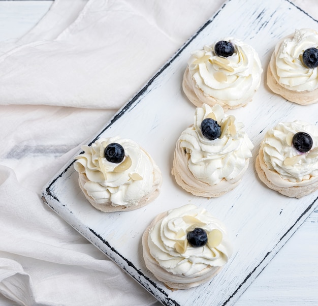 Baked round meringues with whipped cream 