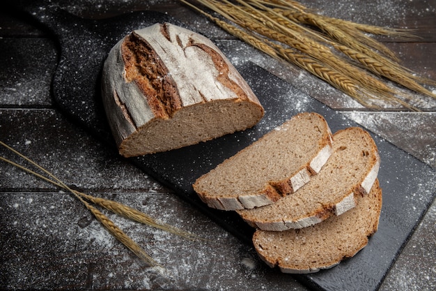 Baked rye bread on wooden table.