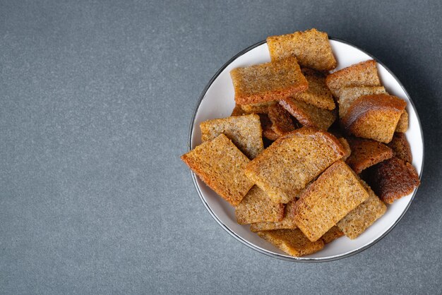 Baked rye croutons on bowl