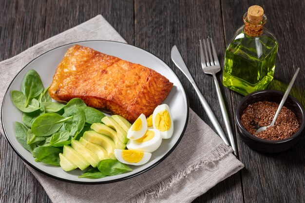 Baked salmon fillet with eggs spinach avocado
