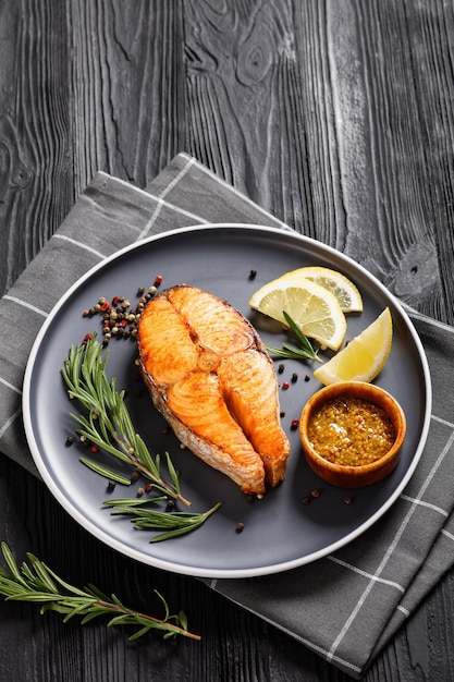 Baked salmon steak on a plate top view