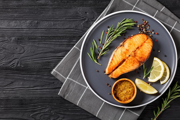 Baked salmon steak on a plate top view