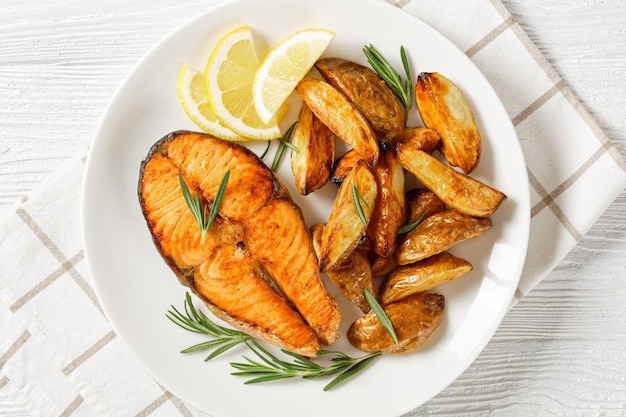 Baked salmon steak and potatoes on a plate