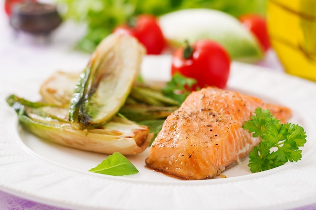 Baked salmon with Italian herbs and garnished with chicory