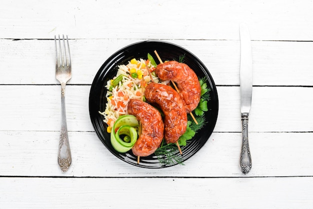 Baked sausages with rice In a black plate Top view Free copy space