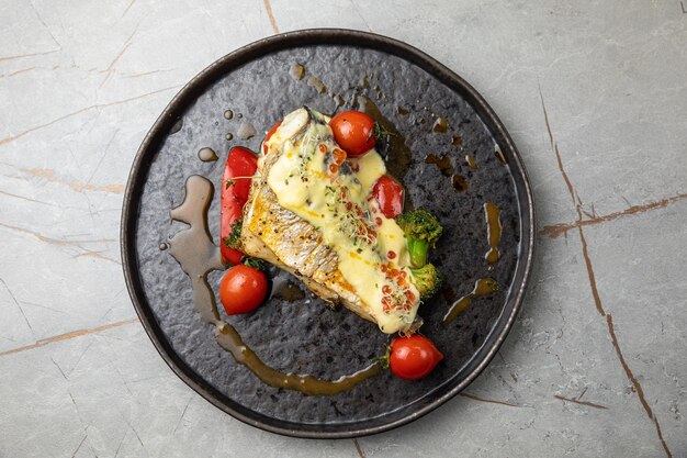 baked sea bream fish with tomatoes peppers sauce and broccoli